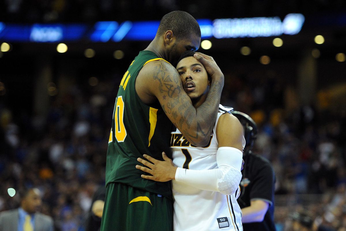 Phil Pressey consoled by Kyle O'Quinn after the Spartans' upset win over the Missouri Tigers.