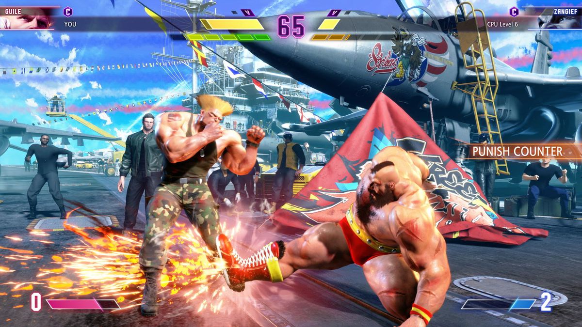 Zangief kicks Guile on a stage set on an aircraft carrier in a screenshot from Street Fighter 6