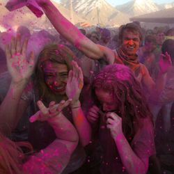 Marlee Taylor and Jessica Hunter get doused with pink chalk at the Holi Festival of Colors at the Krishna Temple in Spanish Fork on Saturday, March 30, 2013. 