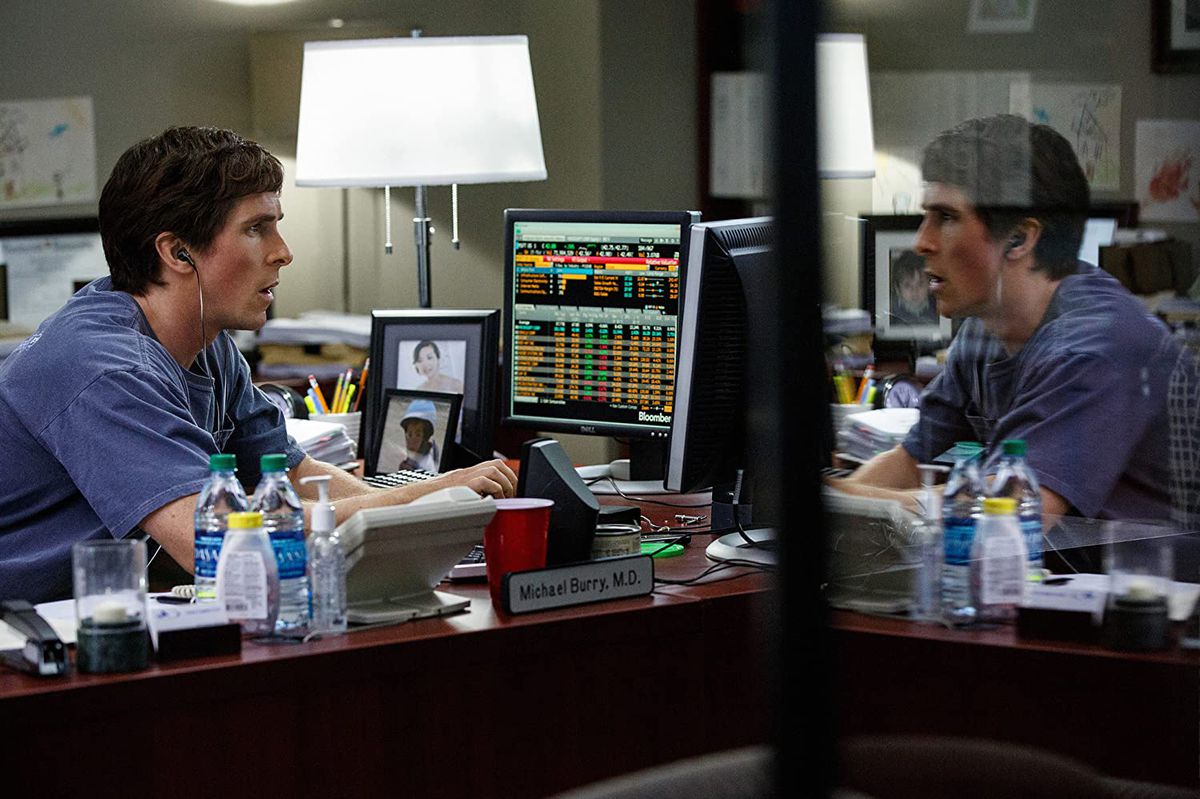 Christian Bale stares at a computer screen in a still from The Big Short