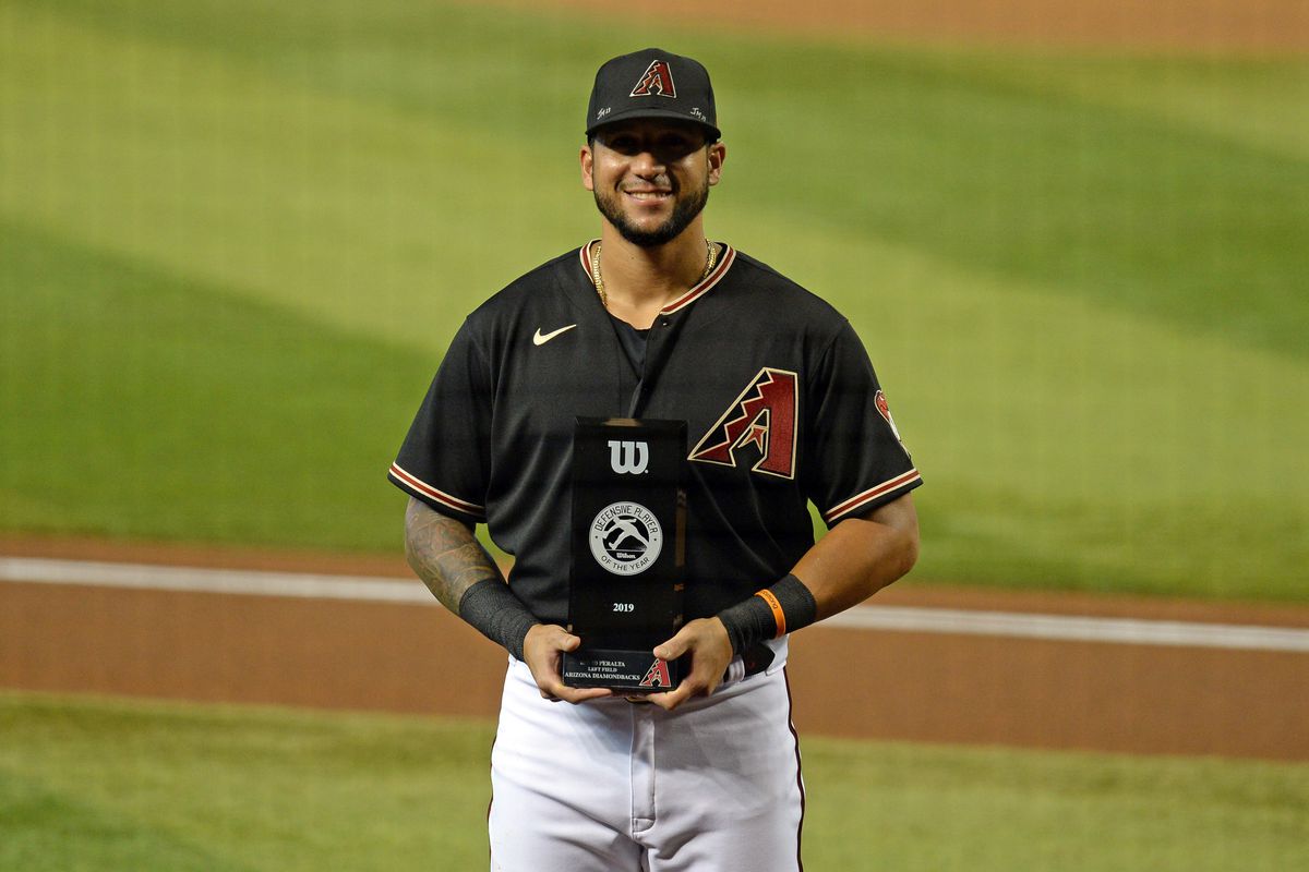 David Peralta poses with the Louisville Defensive Player of the Year Trophy back from before he was traded to the Rays