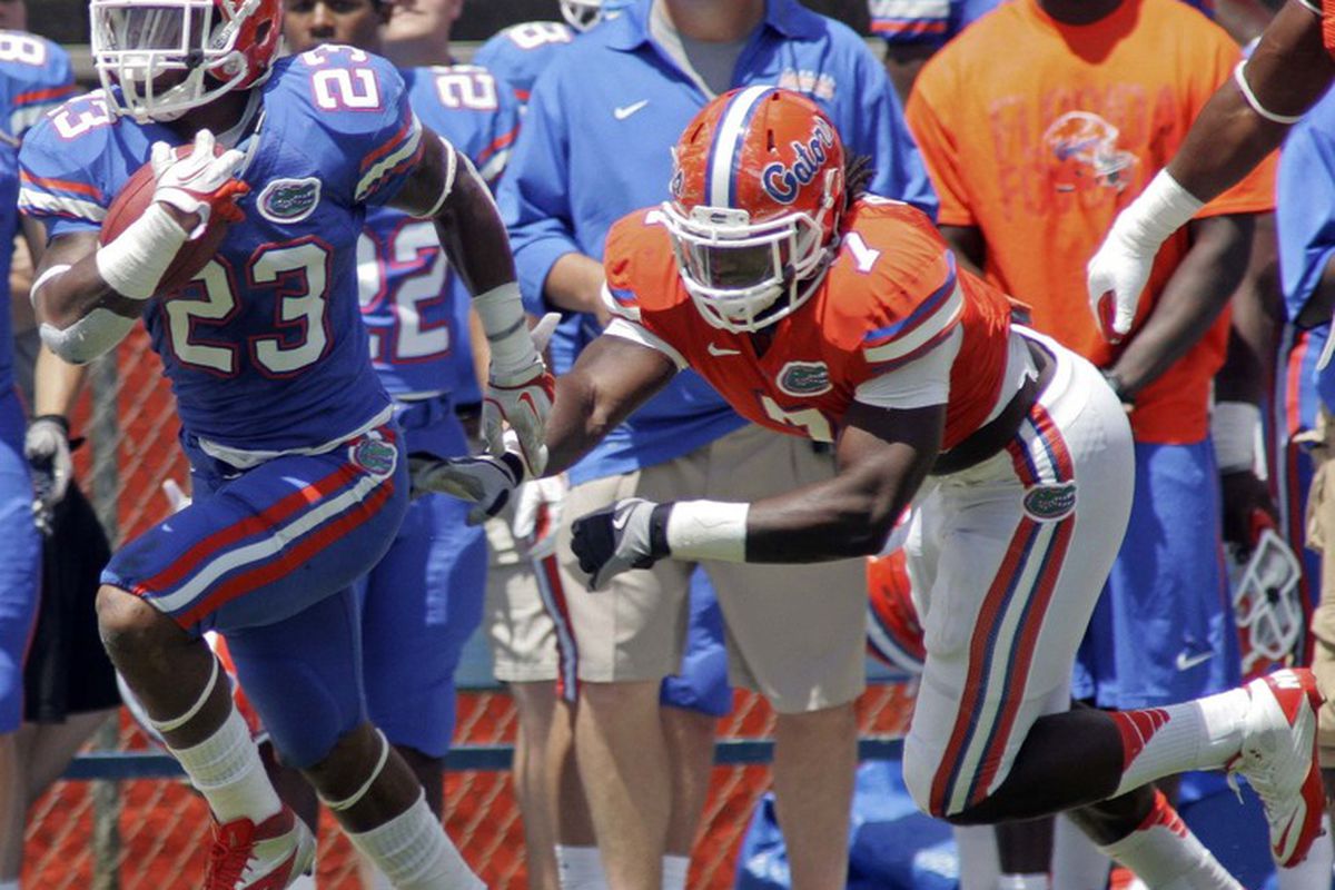 April 7, 2012; Gainesville FL, USA; Florida Gators running back Mike Gillislee (23) runs away from Ronald Powell (7) during the first half of the Florida spring game at Ben Hill Griffin Stadium. Mandatory Credit: Phil Sears-US PRESSWIRE