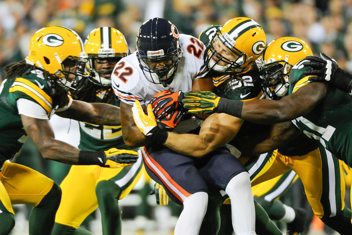 Sept 13, 2012; Green Bay, WI, USA;   Chicago Bears running back Matt Forte (22) is stopped by Green Bay Packers defenders during the first quarter at Lambeau Field.  Mandatory Credit: Benny Sieu-US PRESSWIRE