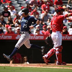 ANAHEIM, CALIFORNIA - SEPTEMBER 18: Dylan Moore #25 of the Seattle Mariners scores on an RBI single hit by Adam Frazier #26 of the Seattle Mariners in the second inning at Angel Stadium of Anaheim on September 18, 2022 in Anaheim, California