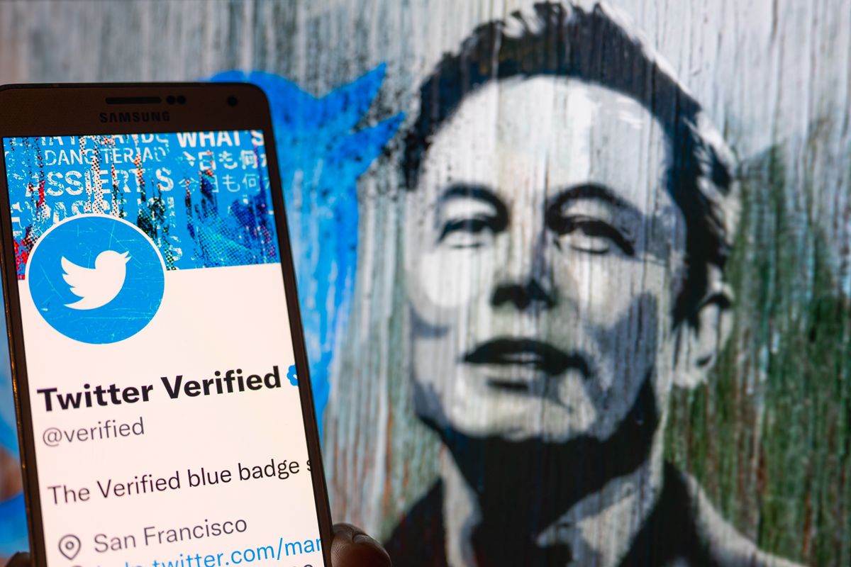 Photo illustration of a phone showing a Twitter verified screen, with a headshot of Elon Musk behind the phone.