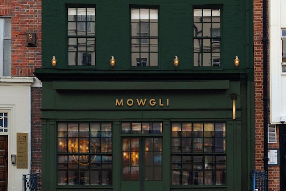 A rendering of the upcoming Mowgli restaurant on Charlotte Street in Fitzrovia, with a dark green frontage and awning and “Mowgli” written in capital letters and gold type