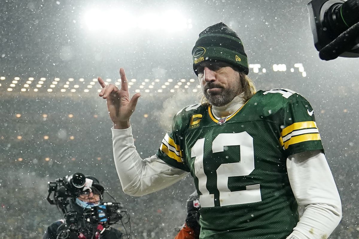 Quarterback Aaron Rodgers #12 of the Green Bay Packers gestures as he exits the field after losing the NFC Divisional Playoff game to the San Francisco 49ers at Lambeau Field on January 22, 2022 in Green Bay, Wisconsin.