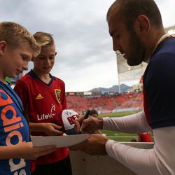 Real Salt Lake forward Yura Movsisyan (14) signs autographs for Brighton Birth and Brock Bennion, both 11, before a U.S. Open Cup game at Rio Tinto Stadium in Sandy on Tuesday, June 14, 2016.