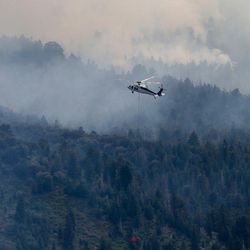 A helicopter fights the Saddle Fire near Pine Valley on Tuesday, June 21, 2016.