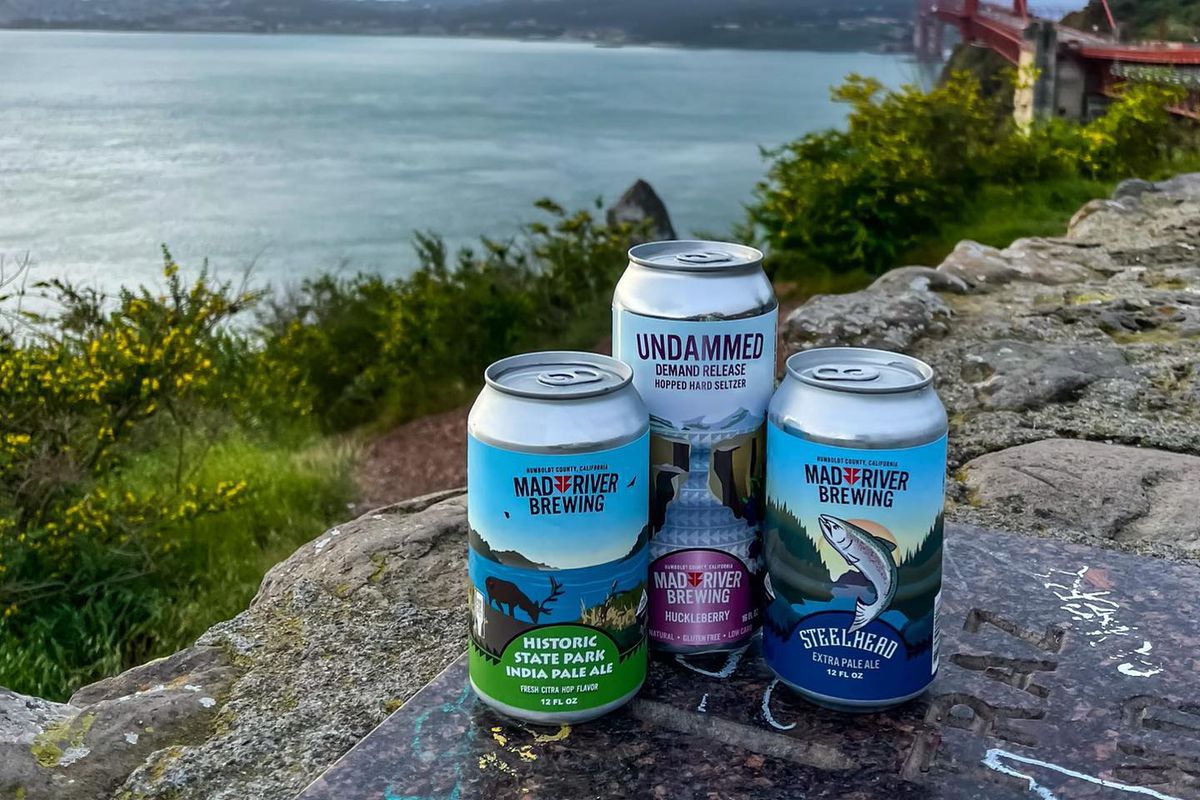 Cans of Mad River Brewery beers in front of the Golden Gate Bridge.