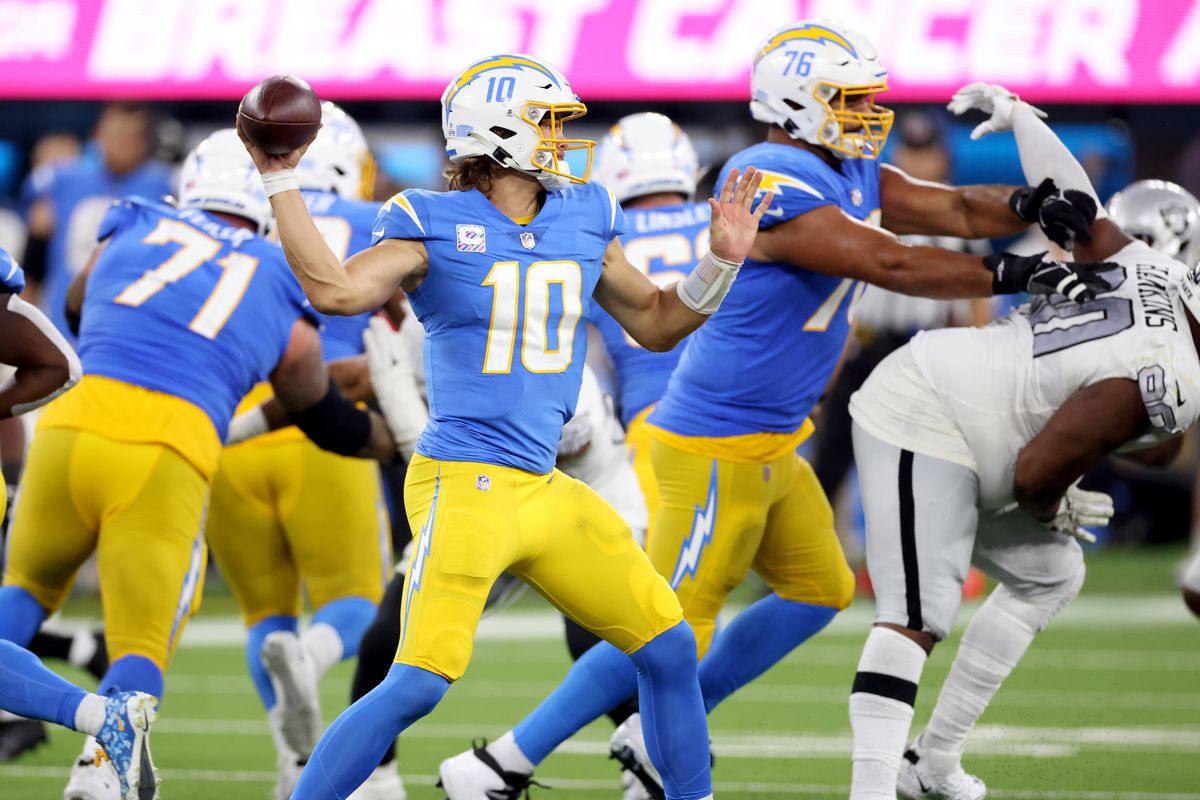 Justin Herbert #10 of the Los Angeles Chargers passes during a 28-14 win over the Las Vegas Raiders at SoFi Stadium on October 04, 2021 in Inglewood, California.