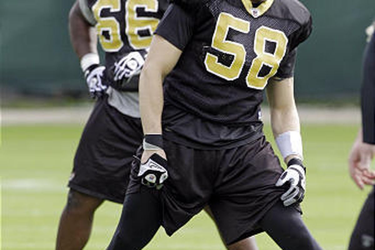 New Orleans Saints defensive tackle Earl Heyman, left, and linebacker Scott Shanle stretch on Wednesday.