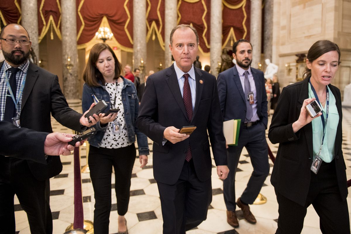 Schiff walks surrounded by reporters on Capitol Hill.