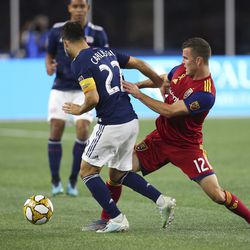 Real Salt Lake forward Brooks Lennon (12) defends against New England Revolution forward Carles Gil (22) during the second half of an MLS soccer match at Gillette Stadium, Saturday, Sept. 21, 2019, in Foxborough, Mass. 