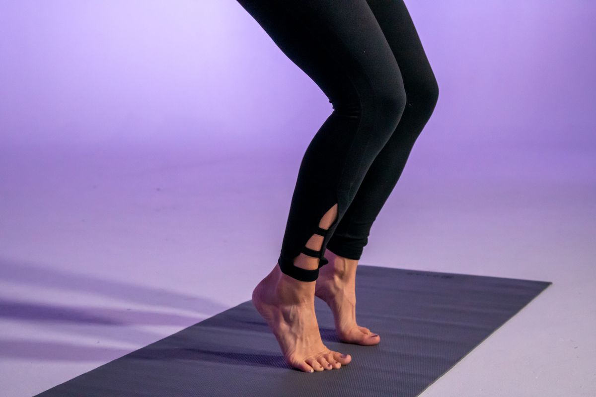 Stephanie Mansour demonstrates a tip toe knee bend that is part of her balancing workout.