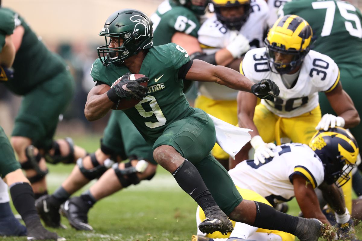 Kenneth Walker III of the Michigan State Spartans looks for yards while playing the Michigan Wolverines during the second half at Spartan Stadium on October 30, 2021 in East Lansing, Michigan.