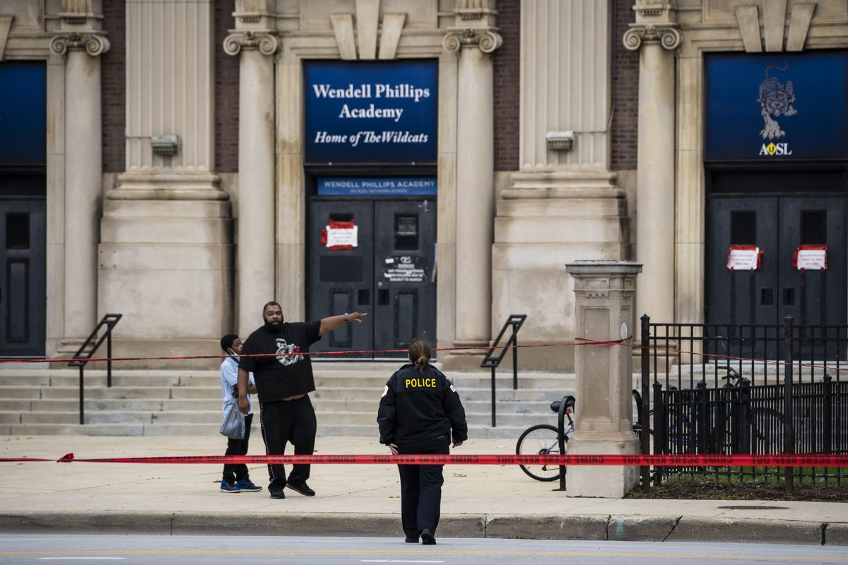 Chicago police investigate after a 14-year-old girl and a security guard were both shot Tuesday afternoon outside Wendell Phillips Academy High School in the 3800 block of South Giles in Bronzeville.