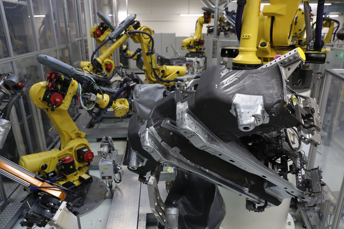 &nbsp;Industrial robots weld portions of the undercarriage of Volkswagen Golf cars at the Volkswagen car factory on May 19, 2017 in Wolfsburg, Germany.