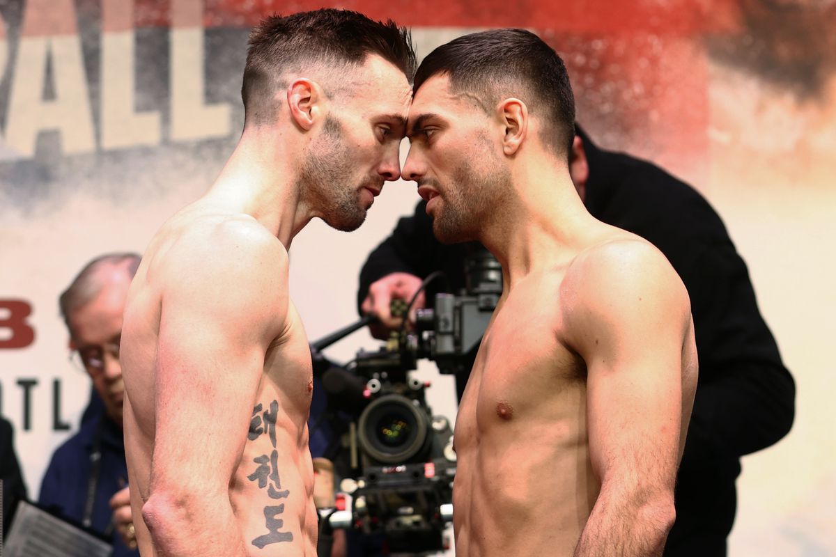 Josh Taylor (L) and Jack Catterall (R) face-off during the weigh in prior to their undisputed super lightweight championship fight at SEC on February 25, 2022 in Glasgow, Scotland.