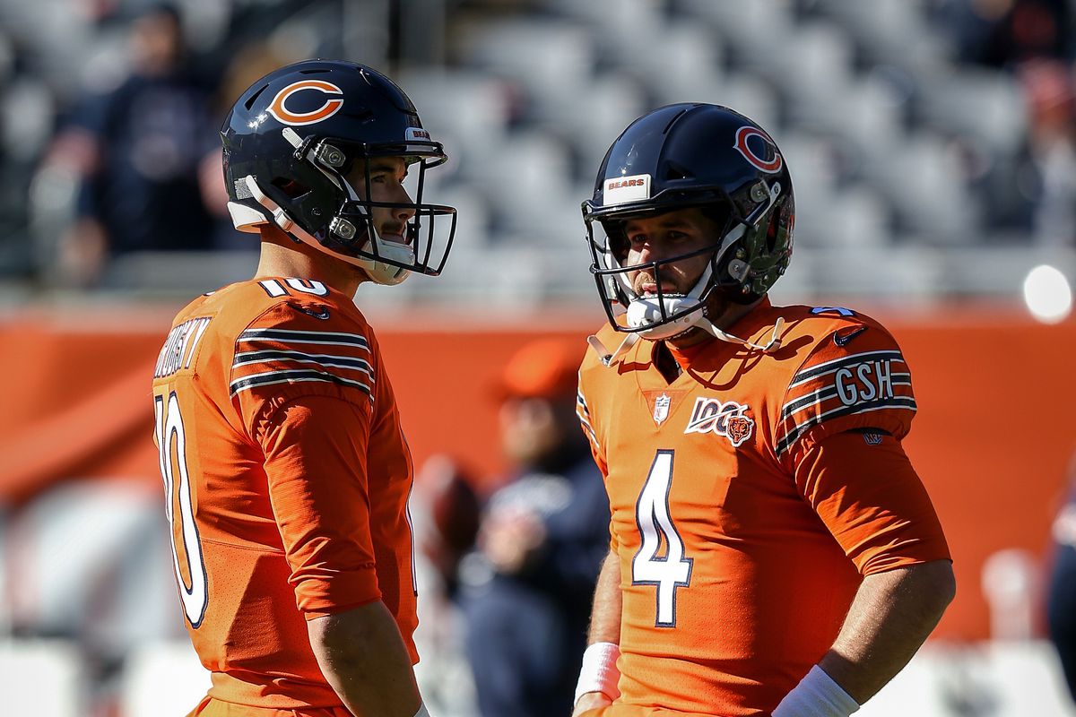 Mitchell Trubisky and Chase Daniel of the Chicago Bears meet before the game against the Los Angeles Chargers at Soldier Field on October 27, 2019 in Chicago, Illinois.