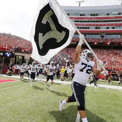 Brigham Young Cougars offensive lineman Ryker Mathews (72) carries the school flag onto the field against Nebraska in Lincoln Saturday, Sept. 5, 2015. BYU won 33-28 on a last-second touchdown pass. 