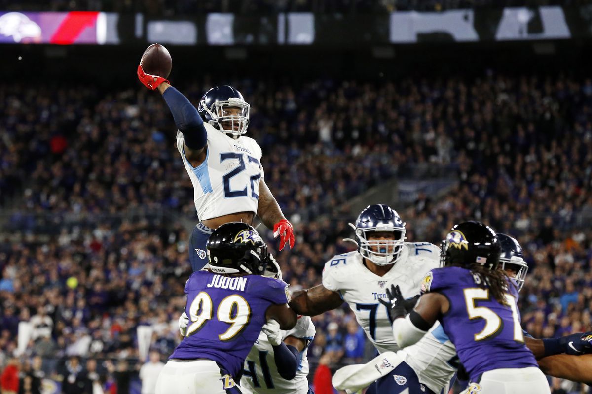 Derrick Henry #22 of the Tennessee Titans throws a touchdown pass to Corey Davis in the third quarter of the AFC Divisional Playoff game against the Baltimore Ravens at M&amp;T Bank Stadium on January 11, 2020 in Baltimore, Maryland.