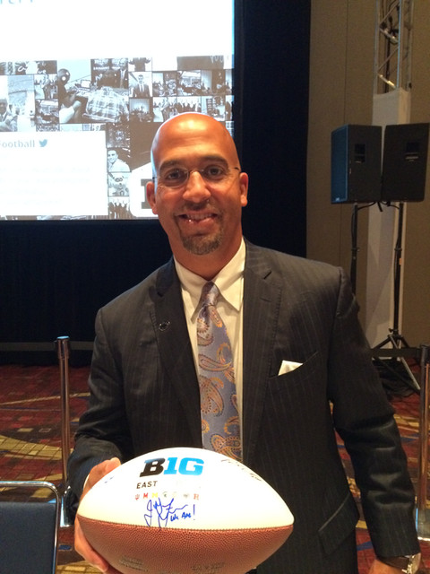 James Franklin signing a football