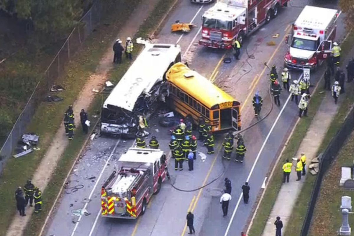 In this frame from video, emergency personnel work at the scene of a fatal school bus and a commuter bus crash in Baltimore, Tuesday, Nov. 1, 2016. (WBAL-TV via AP)