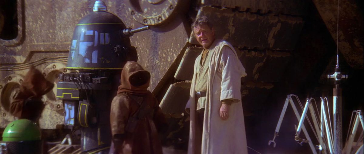 Uncle Owen looks despondently up from the small Jawa who just tried to cheat him out of his money by selling him a broken droid in Star Wars: A New Hope. 