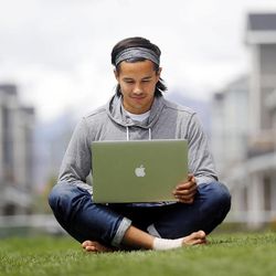 Garrett Gee works on his laptop outside his home in Vineyard, Utah County, Wednesday, May 20, 2015.