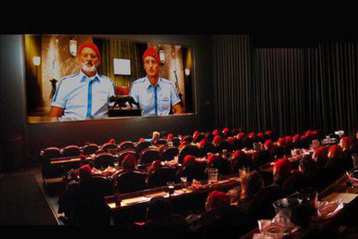 Large crowd watching screen in movie theater