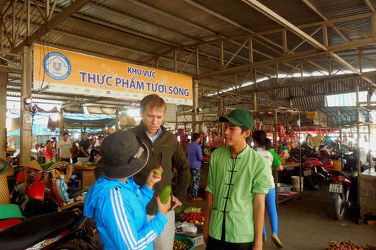 Braden Wages shops for vegetables at a Mekong Delta market. 