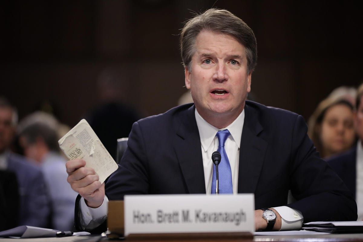 A picture of Brett Kavanaugh clutching a document.