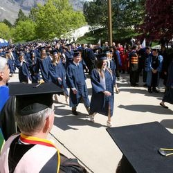 BYU students walk toward the Marriott Center doors for spring commencement exercises at BYU Thursday, April 19, 2012.