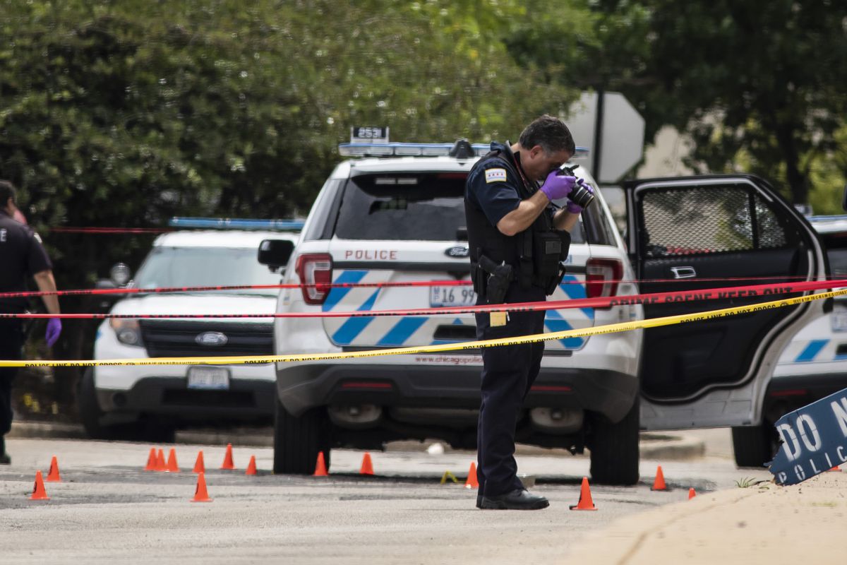 Chicago police investigate after a shooting July 30, 2020, at the 25th District station, 5555 W. Grand Ave., on the Northwest Side, 