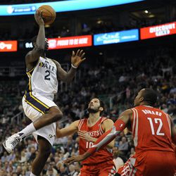 Utah Jazz power forward Marvin Williams (2) goes for a pull up jumper over Houston Rockets small forward Omri Casspi (18) and Houston Rockets power forward Dwight Howard (12) during a game at EnergySolutions Arena on Monday, Dec. 2, 2013.