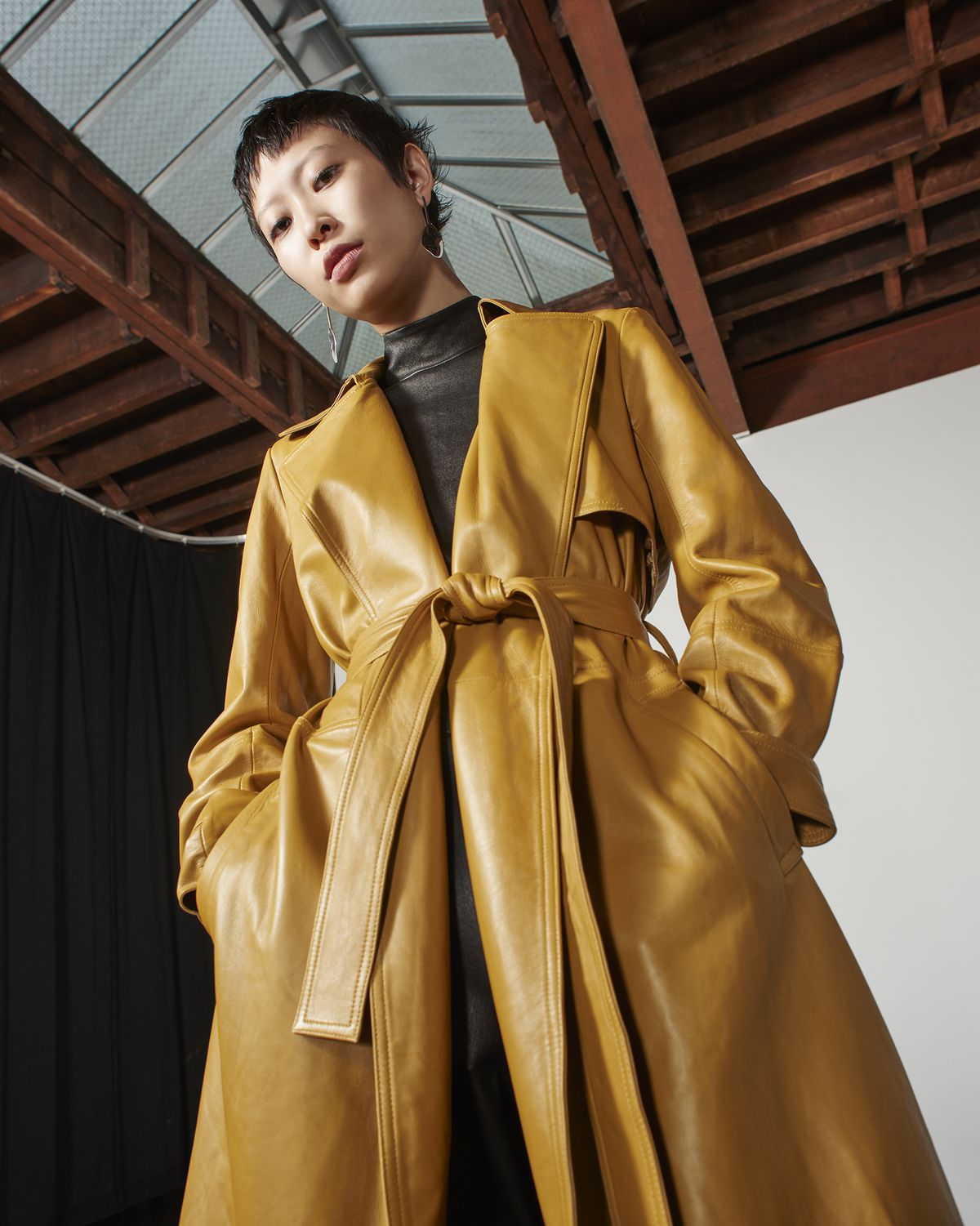 A model in a tan trench coat