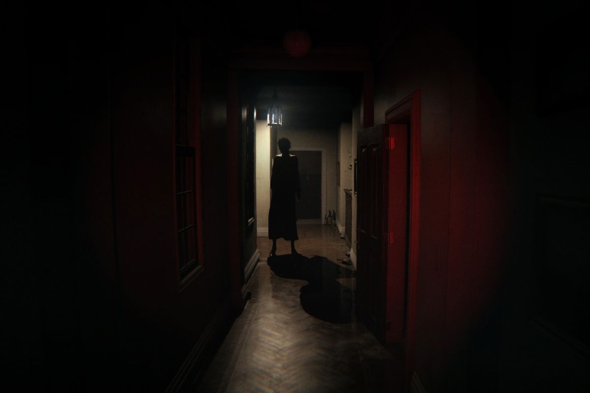P.T.’s ghost, Lisa, stands in a dark hallway