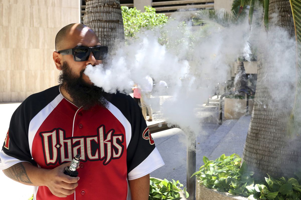 Trevor Husseini exhales a vape cloud in Honolulu on Thursday, March 28, 2019. Hawaii lawmakers are considering outlawing flavored tobacco and electronic cigarette liquids like Maui Mango and Cookie Monsta in an effort to stop escalating teenage vaping. | 