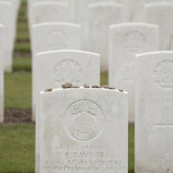Stones are left as a memento atop a WWI soldiers grave at Tyne Cot cemetery in Zonnebeke, Belgium on Monday, April 15, 2013. With nearly 12,000 graves the cemetery is the largest Commonwealth war cemetery in the world in terms of burials. Renovations are currently underway at the cemetery to accommodate visitors for upcoming centenary events which begin in 2014. 