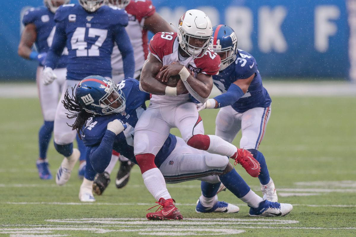 Arizona Cardinals running back Chase Edmonds is tackled by New York Giants linebacker Markus Golden and defensive back Grant Haley during the second half at MetLife Stadium.