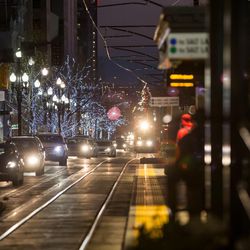 Pedestrians, cars and trains bustle along Main Street in downtown Salt Lake City on Wednesday, Dec. 7, 2016.