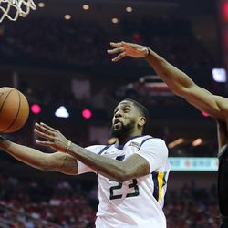 Utah Jazz forward Royce O'Neale (23) goes to the basket with Houston Rockets guard James Harden (13) trailing as the Utah Jazz and the Houston Rockets play game two of the NBA playoffs at the Toyota Center in Houston on Wednesday, May 2, 2018.
