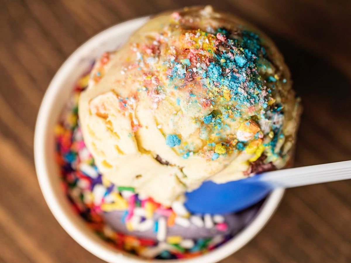 A vanilla scoop in a cup with sprinkles