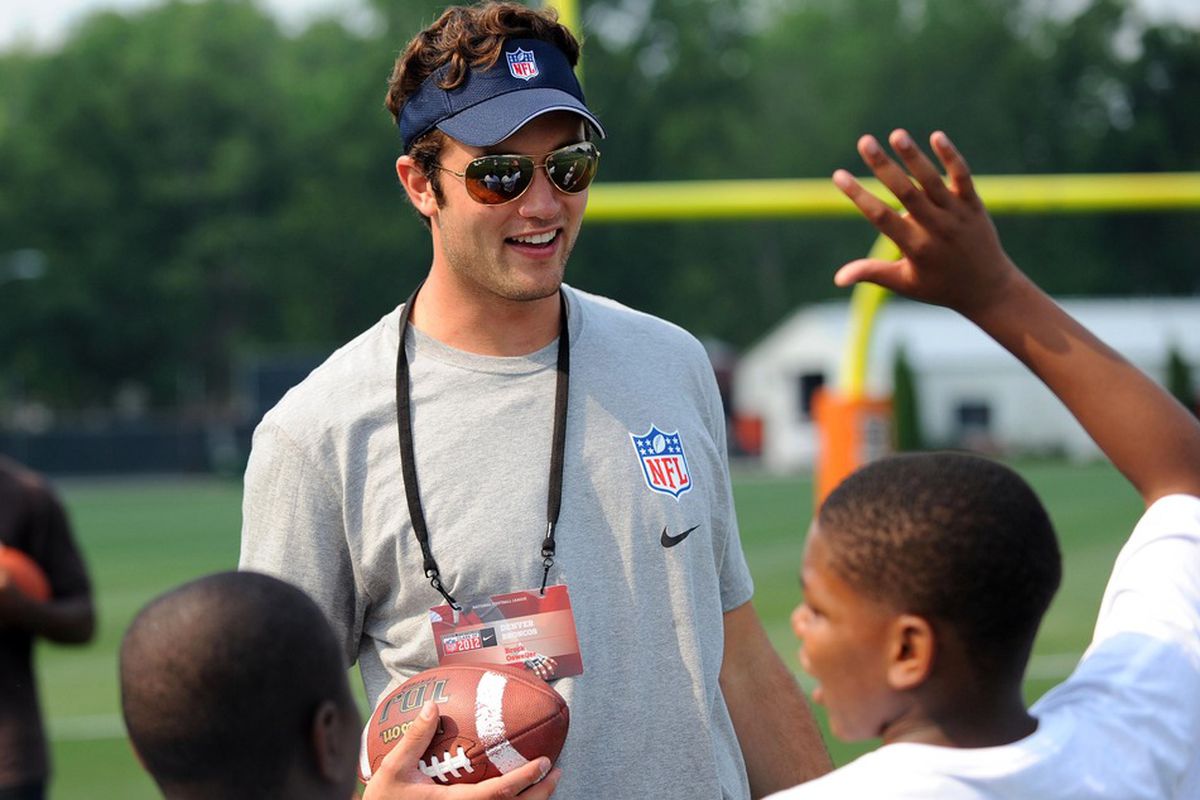 June 29, 2012; Berea, OH USA: Denver Broncos quarterback Brock Osweiler works with youngsters during the AFC rookie symposium at the Cleveland Browns Training Facility.  Mandatory Credit: Eric P. Mull-USPRESSWIRE