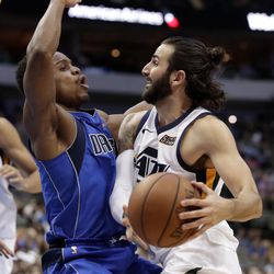 Dallas Mavericks guard Yogi Ferrell (11) takes a charge from Utah Jazz guard Ricky Rubio (3) during the second half of an NBA basketball game Thursday, March 22, 2018, in Dallas. (AP Photo/Tony Gutierrez)