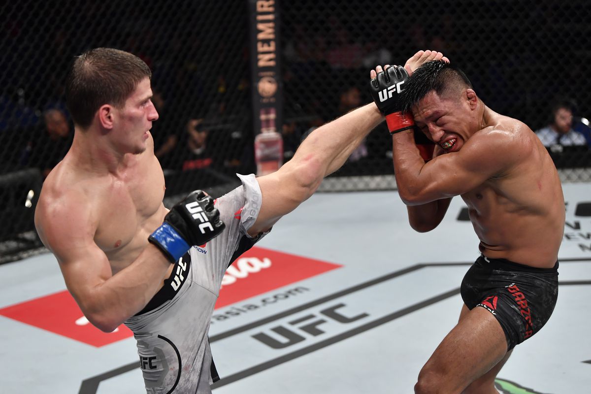 Movsar Evloev of Russia kicks Enrique Barzola of Peru in their featherweight bout during the UFC Fight Night event at Singapore Indoor Stadium on October 26, 2019 in Singapore.