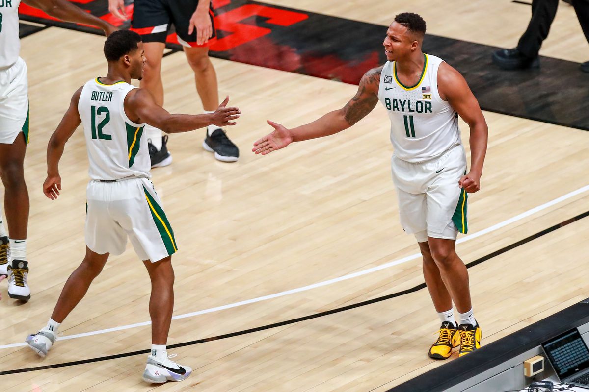 Guards Mark Vital and Jared Butler of the Baylor Bears high five during the first half of the college basketball game against the Texas Tech Red Raiders at United Supermarkets Arena on January 16, 2021 in Lubbock, Texas.