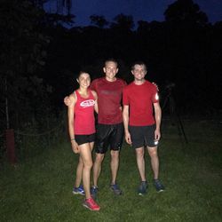 Sarah Sellers, left, her husband Blake Sellers, and Sarah's brother Ryan Callister, right, after finishing a rainy run last summer in Borneo.