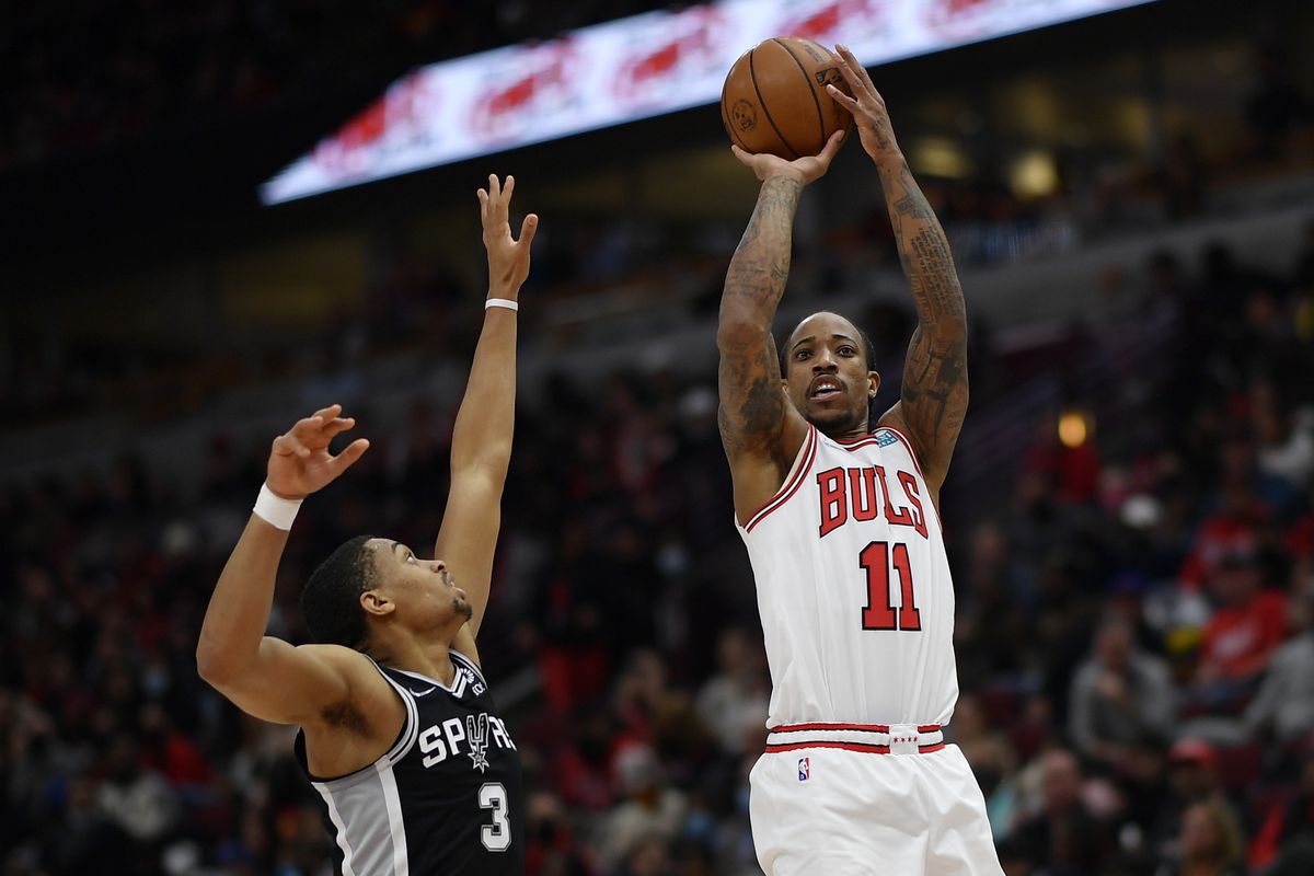 DeMar DeRozan #11 of the Chicago Bulls shoots in the second half against Keldon Johnson #3 of the San Antonio Spurs at United Center on February 14, 2022 in Chicago, Illinois.